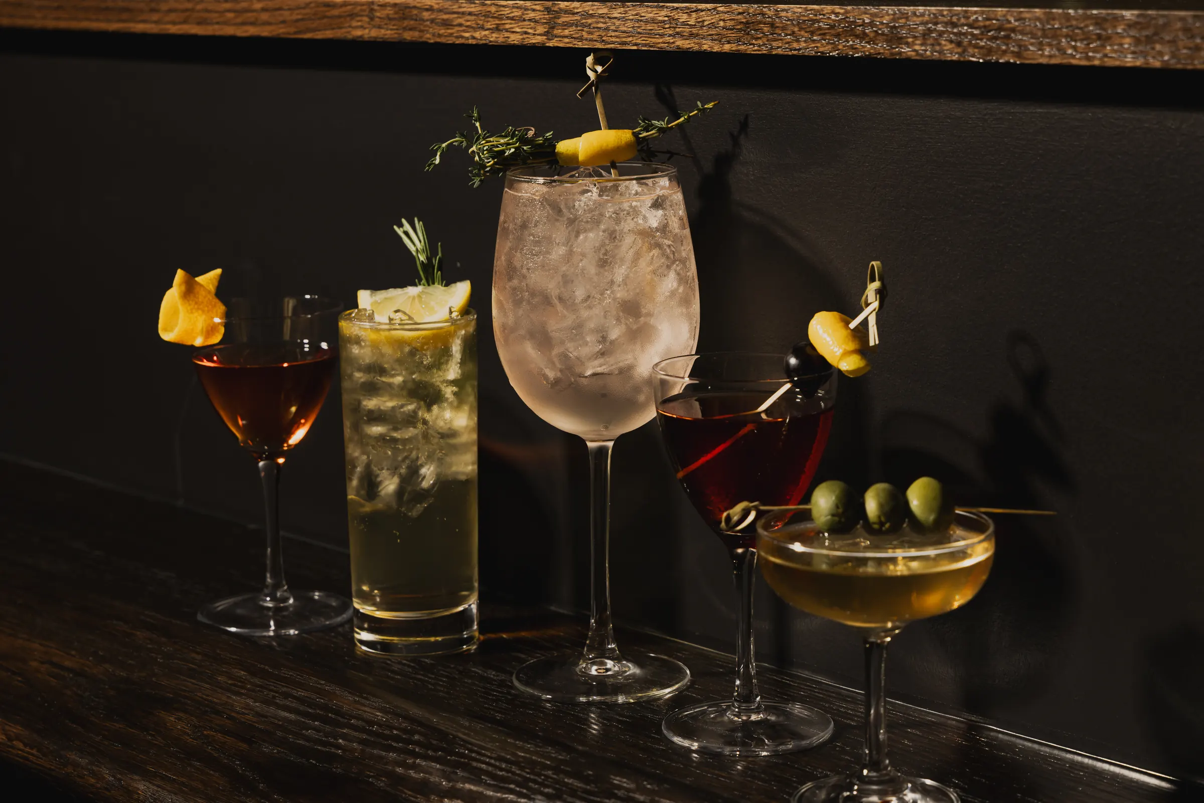 A lineup of vermouth cocktails, including a martini and a vermouth spritz