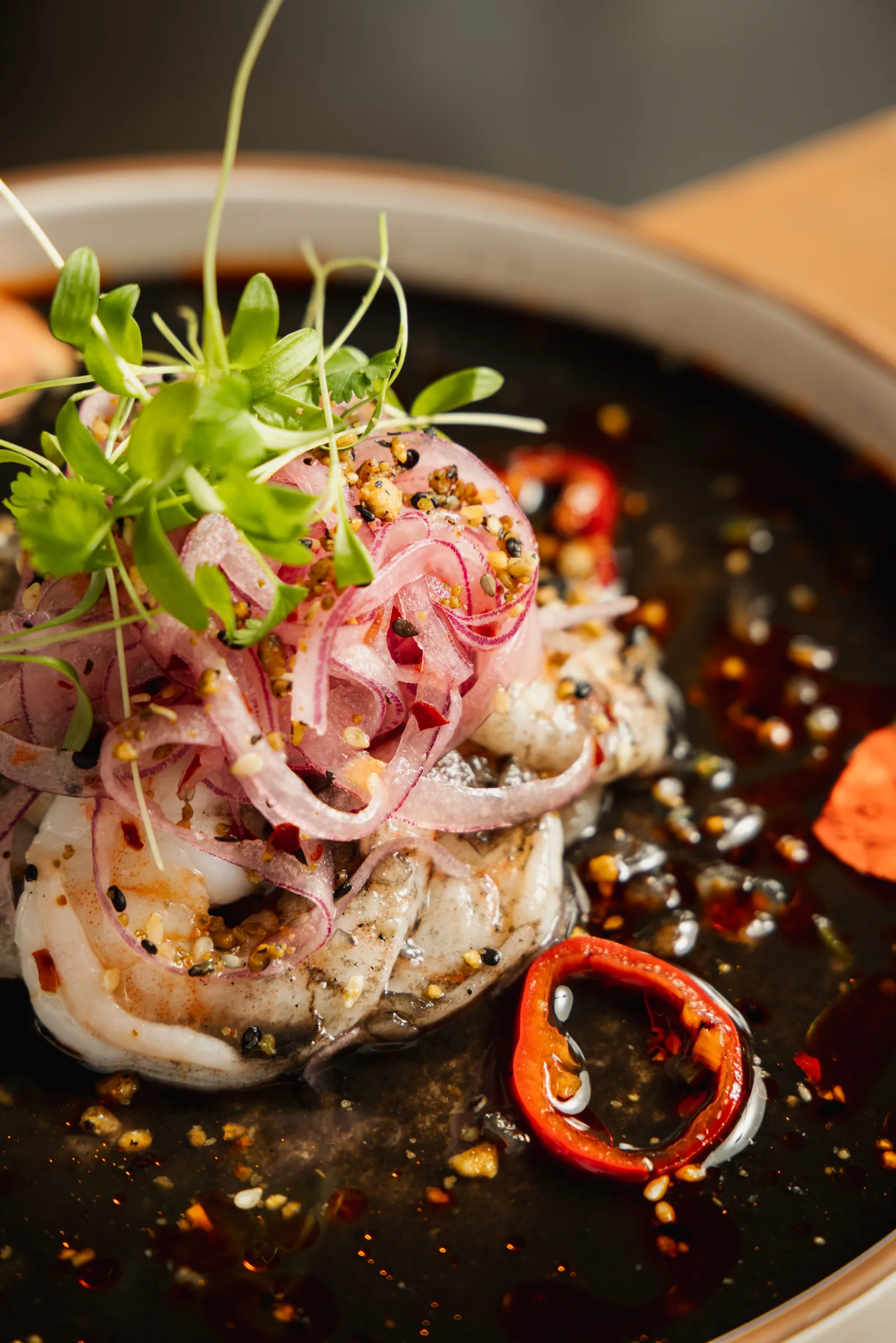 Ceviche plated with pickled onion and chilli