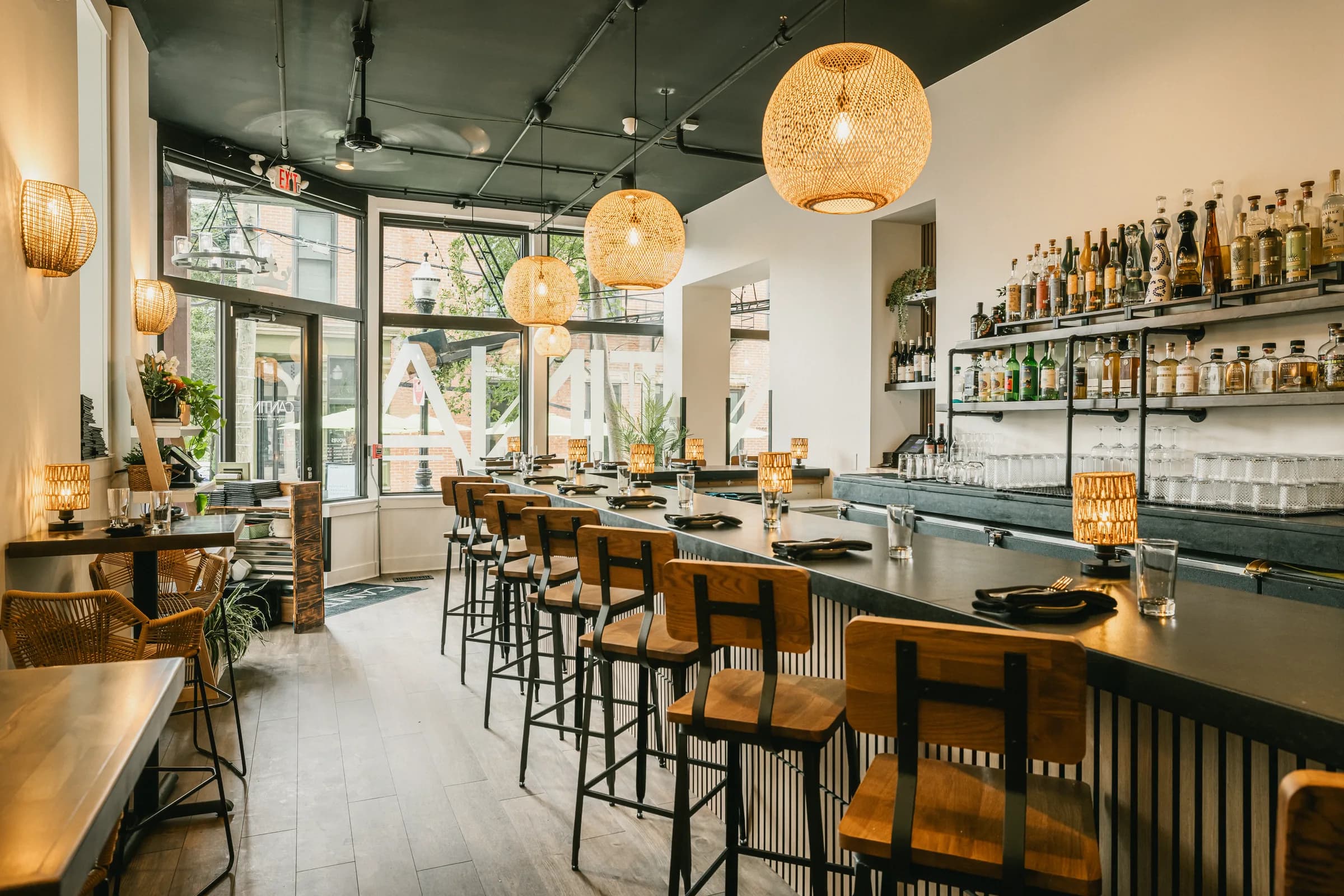 The dining room at Crown Cantina, the bar running the length of the room under woven pendant lights