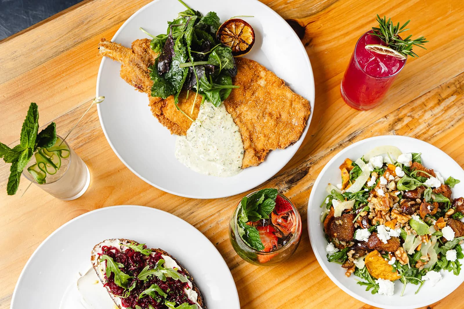 A spread of plates across a table at Crown Republic Gastropub