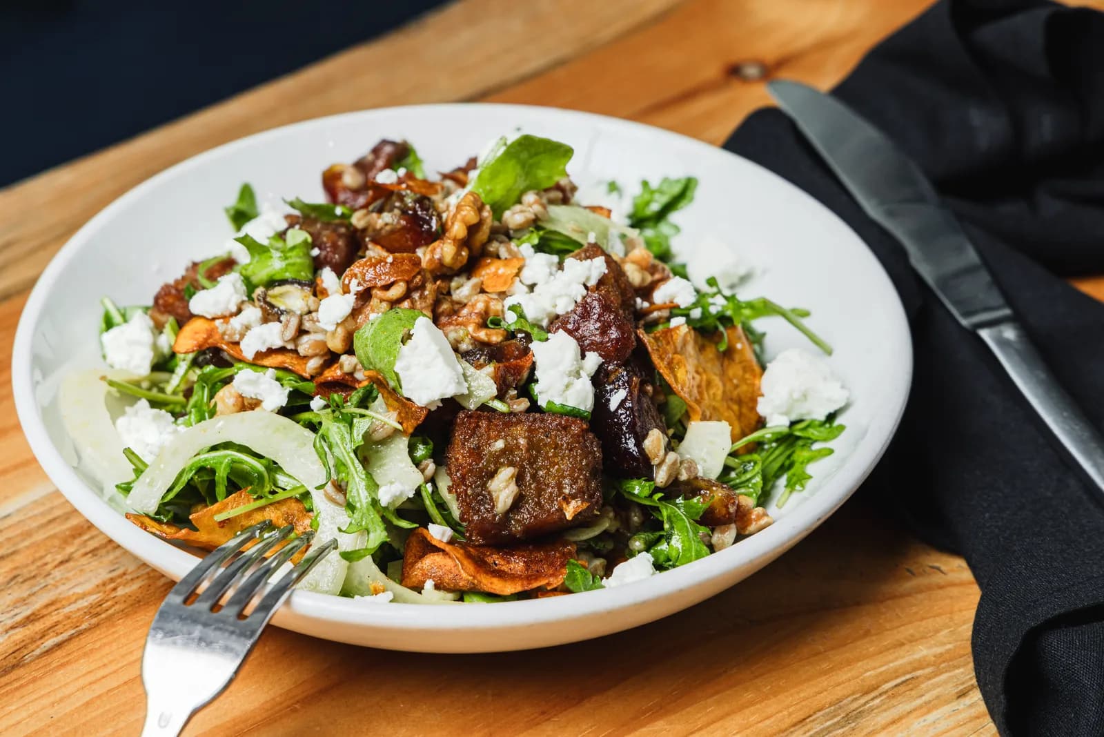 A seasonal salad with goat cheese and walnuts