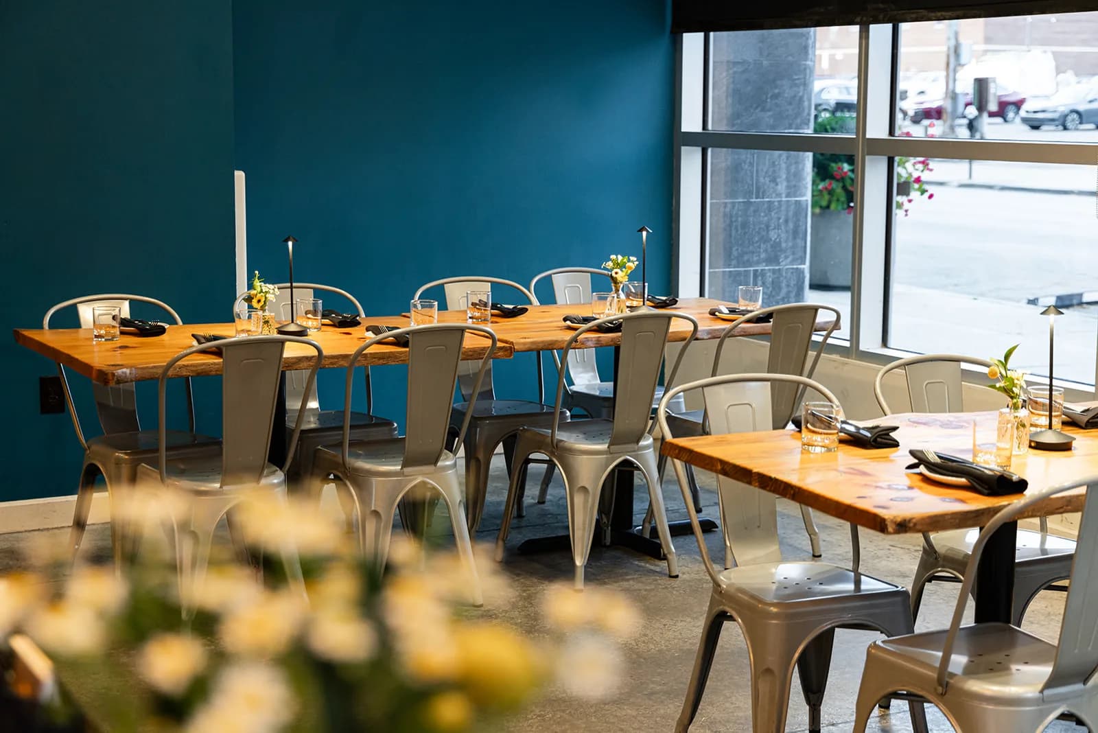 The dining room at Crown Republic Gastropub, tables set along the tall Sycamore Street windows