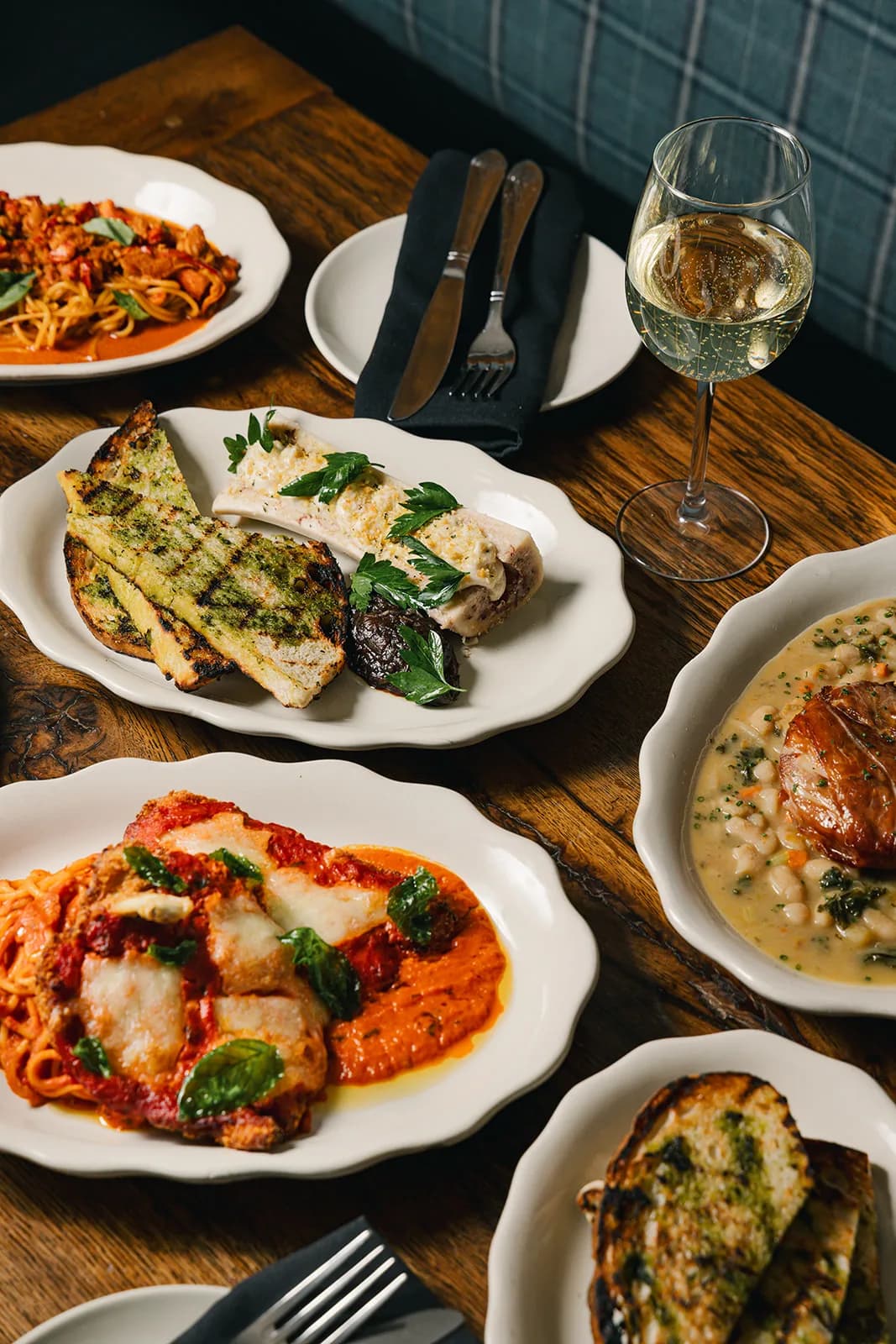 A family-style spread laid across the table at Losanti – Cincinnati