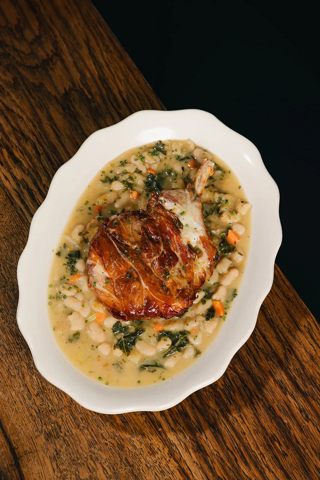 Risotto plated in a scalloped white bowl