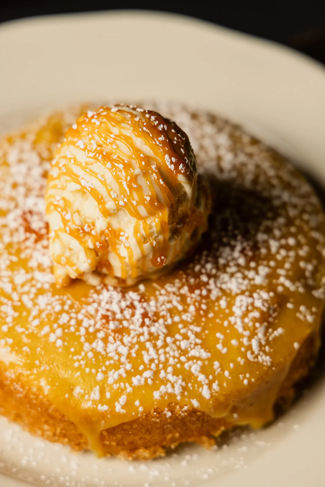 The butter cake, dusted and served warm